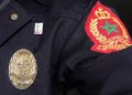 A close-up of a Moroccan police uniform displaying the official badge and insignia of the General Directorate of National Security (DGSN).