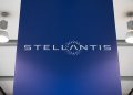 The Stellantis logo displayed on a large blue panel inside a corporate facility.