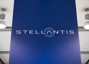 The Stellantis logo displayed on a large blue panel inside a corporate facility.