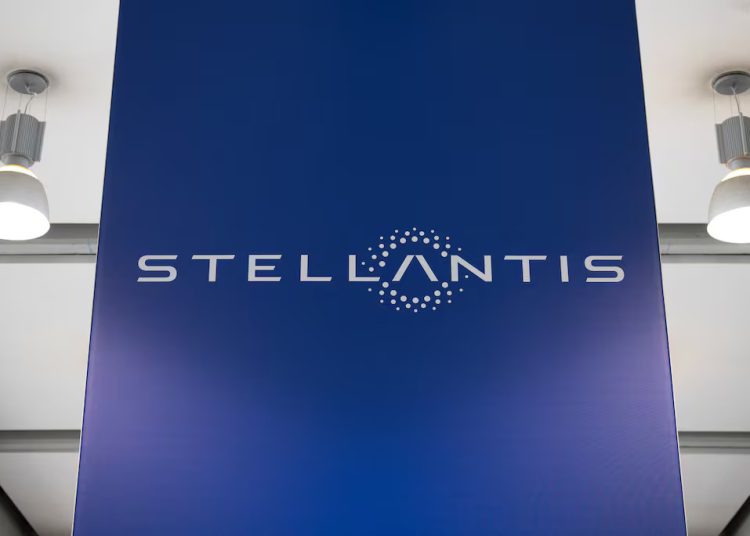 The Stellantis logo displayed on a large blue panel inside a corporate facility.