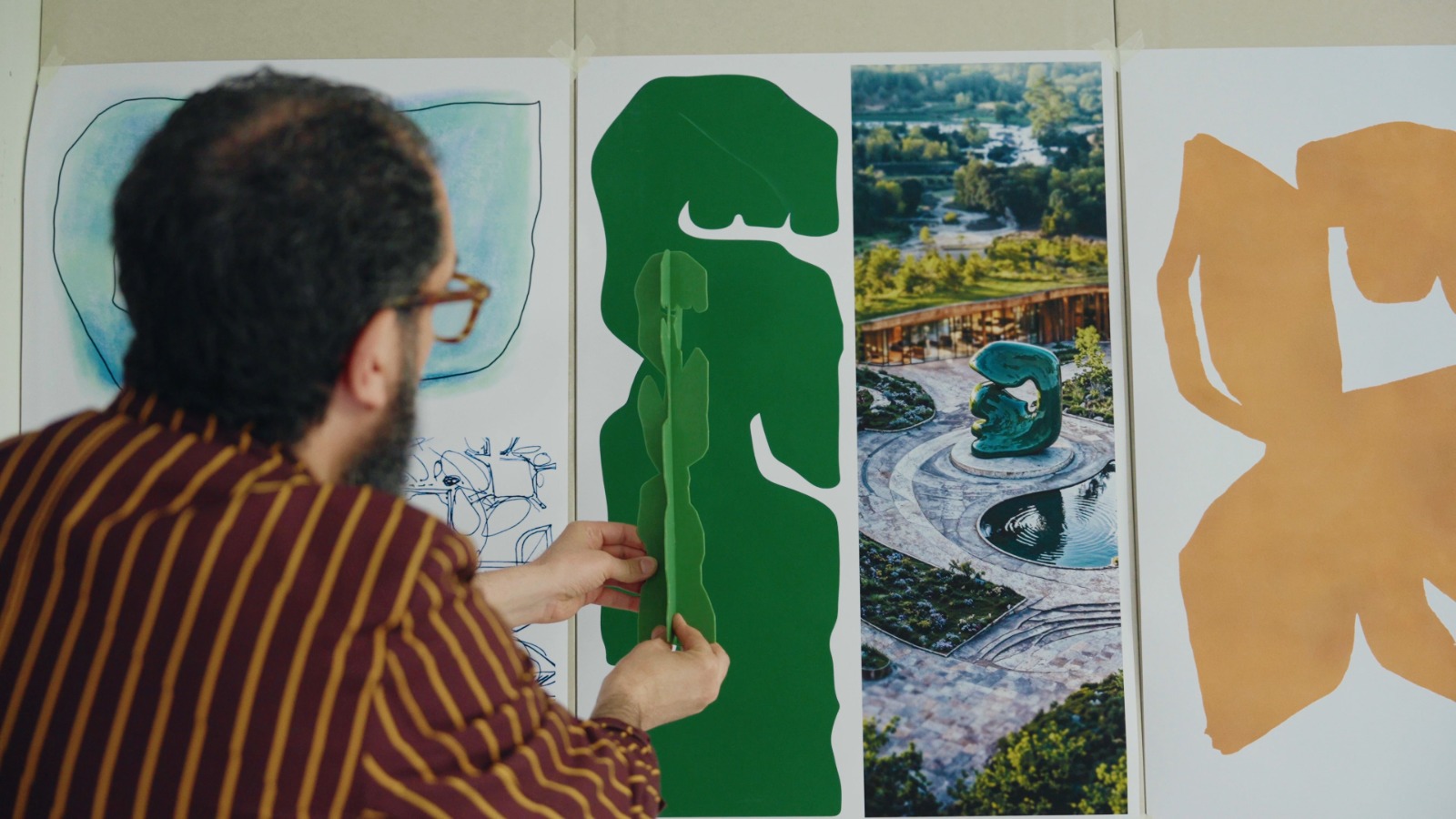 A photo of Moroccan-Dutch artist Hakim El Amrani working on a design in his studio.