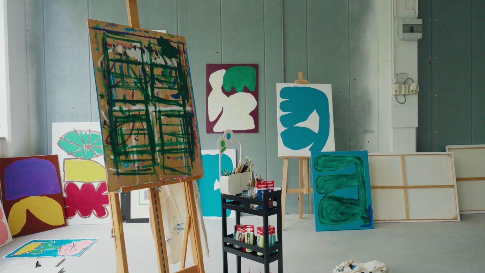 A photo showcasing abstract paintings and colorful artworks in Moroccan-Dutch artist Hakim El Amrani’s studio.