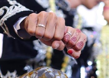 A photo of a Moroccan bride and groom touching fists during their wedding celebration.